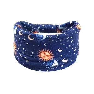Detail of navy blue elastic headband with celestial sun, moon and star prints