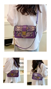 Detail of purple snakeskin crossbody bag with vintage gold hardware and chain strap