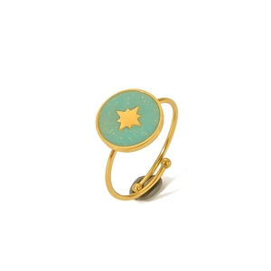 Detail of adjustable gold ring with mint green enamel surface and center star motif