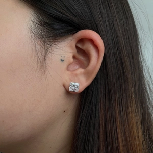 Close-up of S925 sterling silver stud earrings featuring square princess-cut cubic zirconia