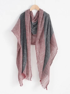 Detailed texture of pink and grey striped linen scarf with natural fringed edges