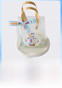 Detail of frosted gift bag with bamboo handles and decorative printed success ribbons