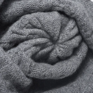 Chunky grey cable knit beanie hat for women featuring a warm wool pompom design