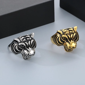 Detailed view of retro tiger head rings in silver and gold finishes for men