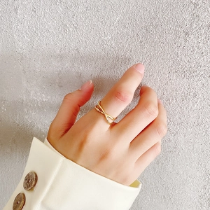 Minimalist 925 sterling silver irregular cross ring in gold finish worn on finger
