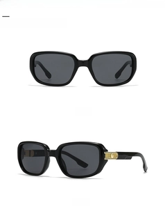 Detail of square pilot sunglasses with gold star embossed accents and black frames
