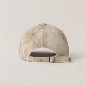 Close-up of adjustable strap and cross rivet on vintage washed khaki baseball cap