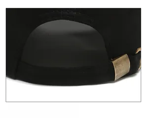 Close-up of black cotton baseball cap with adjustable metal buckle at the back