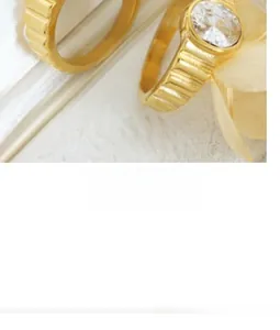 Macro detail of 18K gold plated ribbed ring with large round zircon stone inlay