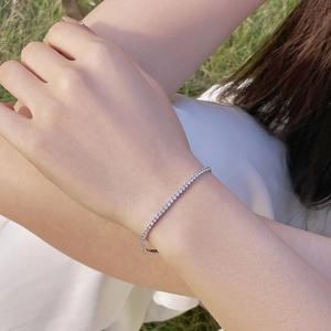 Detailed close-up of a 2mm S925 sterling silver tennis bracelet with cubic zirconia on wrist