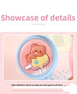Detail of blue folding hairbrush with cartoon bear and integrated HD makeup mirror