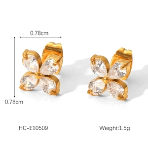 Macro shot of gold floral stud earrings featuring four drop-shaped zircon petals