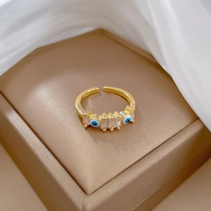 Gold plated open eye ring with cubic zirconia inlay on a white organza base