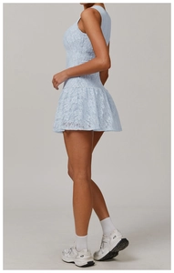 Detailed side view of light blue sleeveless lace dress with pleated floral pattern hem