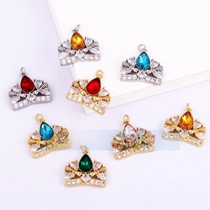 Macro detail of crown shaped pendants with colorful teardrop stones and CZ stones