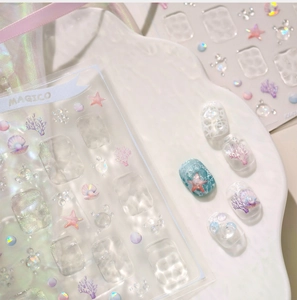 Macro shot of 3D embossed ocean nail stickers with pastel coral and seashell details