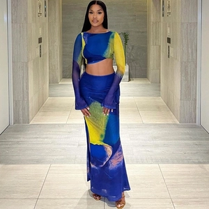 Detail of blue and yellow abstract print mesh crop top with flared sleeves and maxi skirt