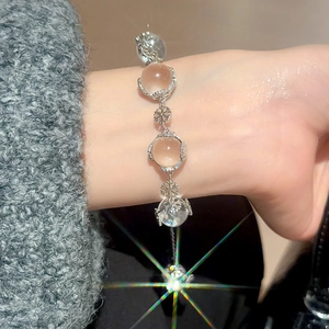 Detailed close-up of a women's beaded bracelet featuring snowflake charms on a wrist