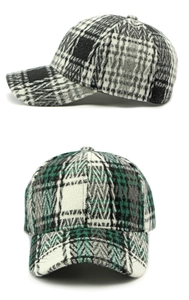 Detail of tweed checkered baseball caps in black and green patterns on white background