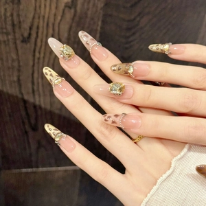 Long almond-shaped nude pink press-on nails with brown leopard print and yellow gems