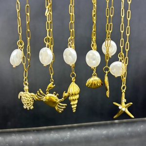 Detailed set of five gold stainless steel necklaces with sea creature charms and pearls