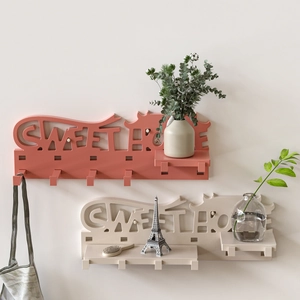 Macro detail of Sweet Home wall shelf with hooks and small display platform