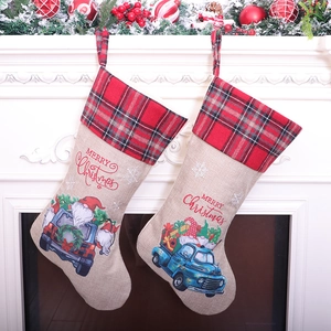 Blue truck Santa Christmas stockings hanging on fireplace with festive holiday decor