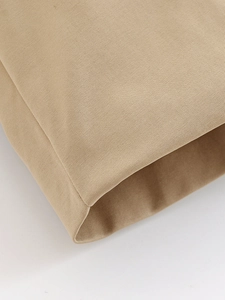 Detail of khaki twill fabric texture and professional stitching on casual short trench coat