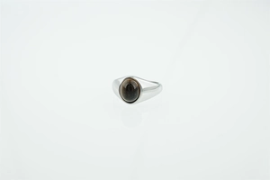 Macro shot of polished titanium steel ring with an oval dark turquoise gemstone inlay