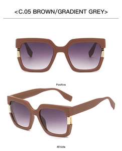 Macro detail of brown square sunglasses with golden metal hinges and gradient grey lenses