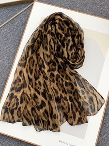 Detail of leopard print scarf showing lightweight voile fabric and neat stitching edge