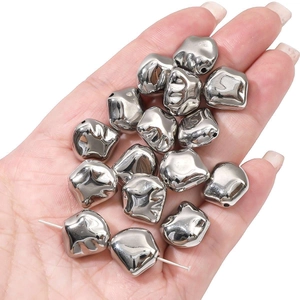 Close-up of silver CCB star and bone beads held in hand for DIY jewelry making