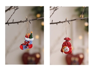 Detailed view of hand-painted Christmas stocking and snowman resin hanging ornaments