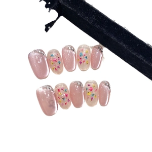 Handmade cat-eye press-on nails with pink glitter, real dried flowers and pearls