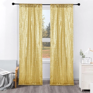 Detail view of gold sequin curtains hanging on a black rod in a bright living room setup
