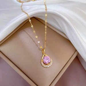 Detailed view of pink round gemstone pendant with sparkling diamonds in a gold box