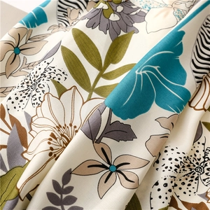 Close-up of lightweight silk scarf with tropical floral prints and zebra textures