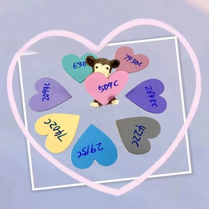 Detail showing heart-shaped colorful sticky notes in pastel pink, blue, and yellow shades