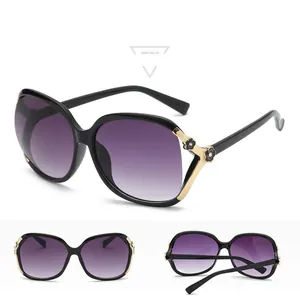 Polarized women's oversized sunglasses with black frame and golden camellia floral temple detail