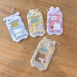 Detail view of cute cartoon animal card holders with beads chains on a wooden table