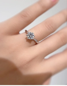 Detailed view of 1ct moissanite ring with six-prong setting on a model hand