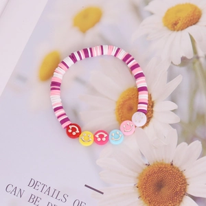 Close-up of handmade Bohemian beaded bracelet with smiley faces and colorful clay beads