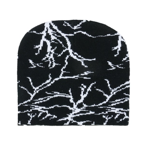 Close-up of the black and white knitted beanie showing lightning pattern and wool texture
