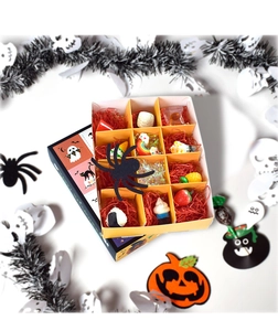 Detail view of a Halloween-themed 9-grid blind box gift set with assorted cute charms
