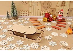 Detailed view of mini wooden Christmas sledge with miniature festive ornaments