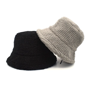 Detail of winter bucket hats in black sherpa fleece and grey striped corduroy texture