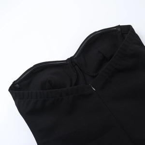 Detail of invisible zipper and non-slip silicone strip on black tube dress