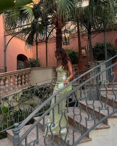 Detail of light green sequined dress with V-neckline and slim fit tailoring