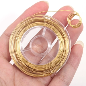 Golden stainless steel wire for DIY jewelry making on a clear plastic spool roll