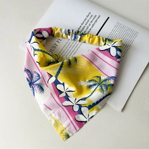 Detailed flat lay of tropical palm pattern headbands with elastic bands on a magazine